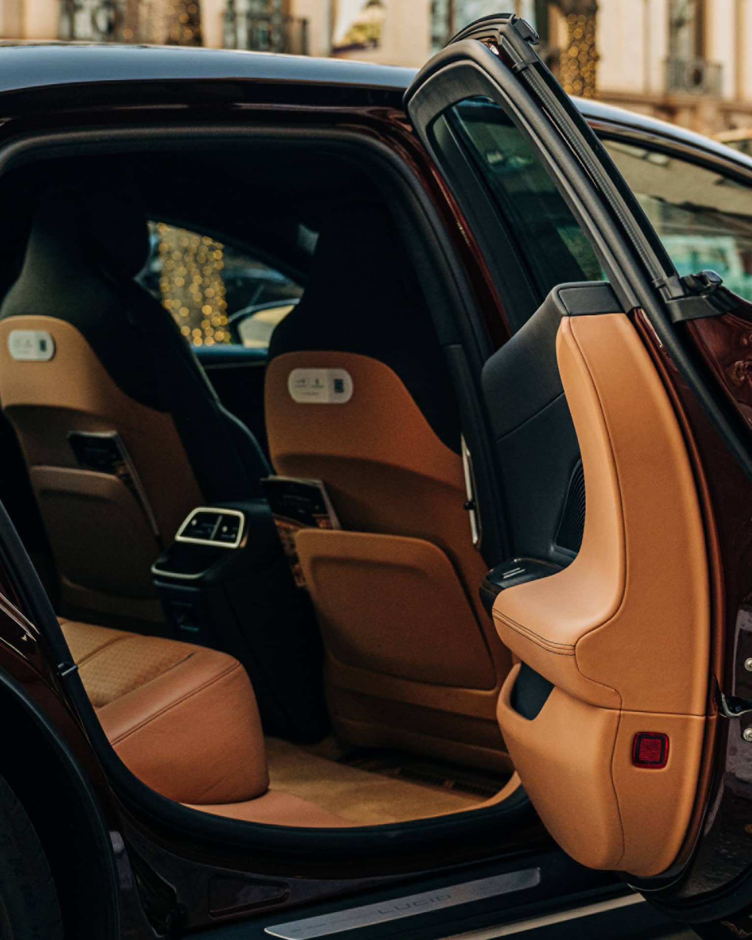 Person wearing a suit and opening a car door