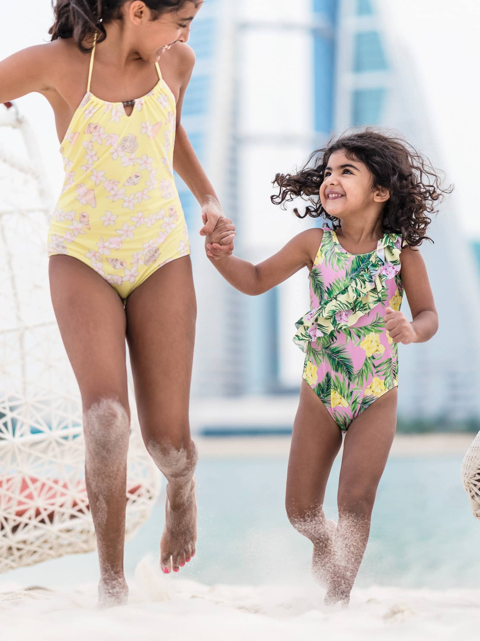 Children running on sandy beach at a luxury resort