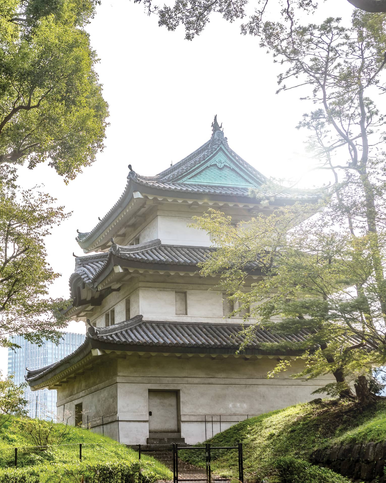Traditional Japanese building with tiered roofs surrounded by trees
