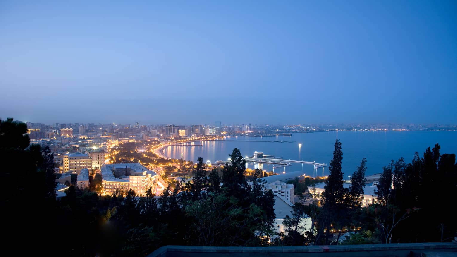 Aerial view of lights of Baku The Old City at night around Caspian Sea coastline