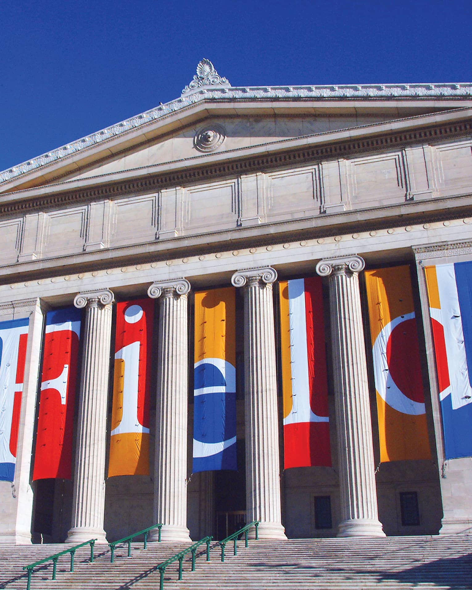 Tall white pillars on exterior of the Field Museum of Natural History, against blue sky