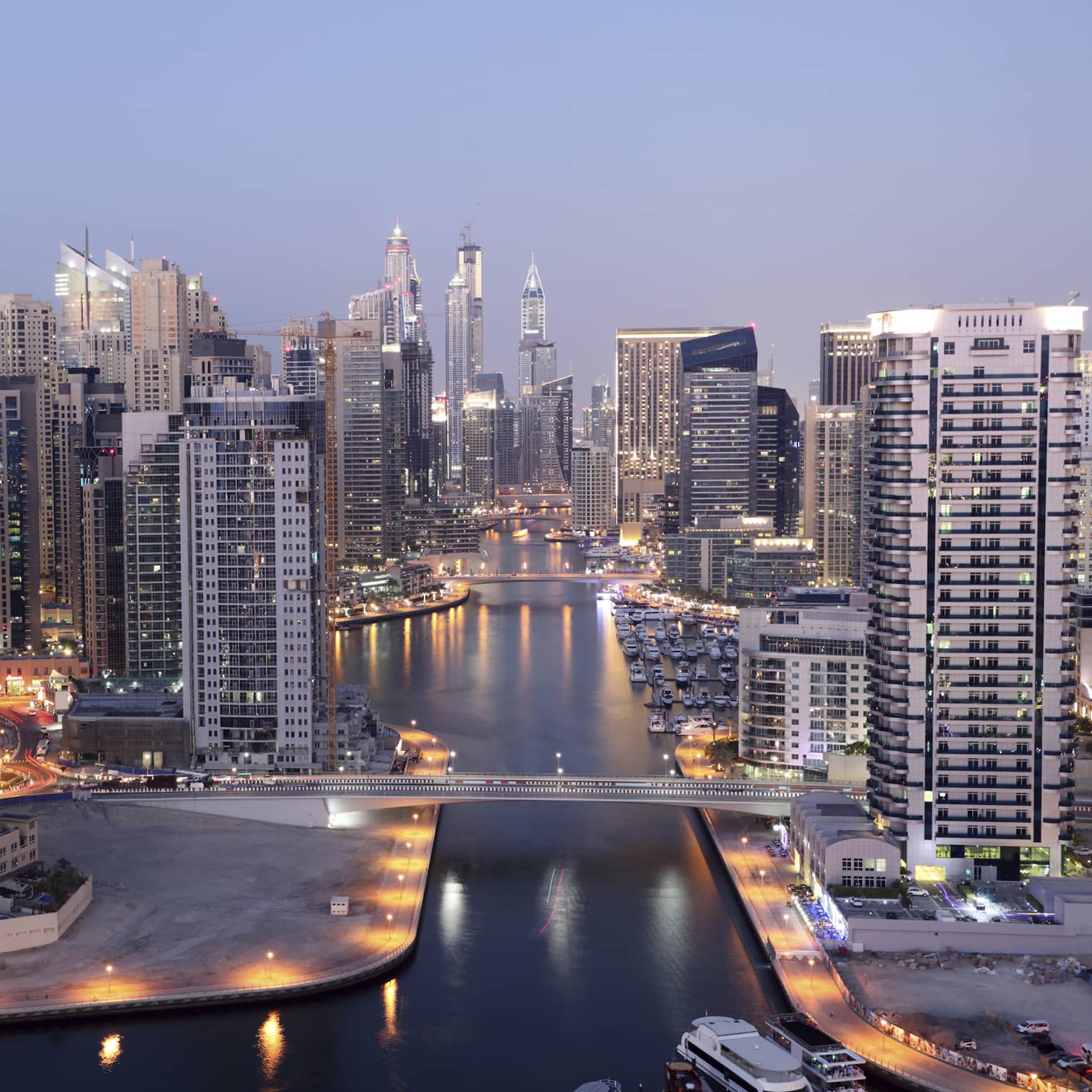 Dubai skyline buildings and marina at dusk