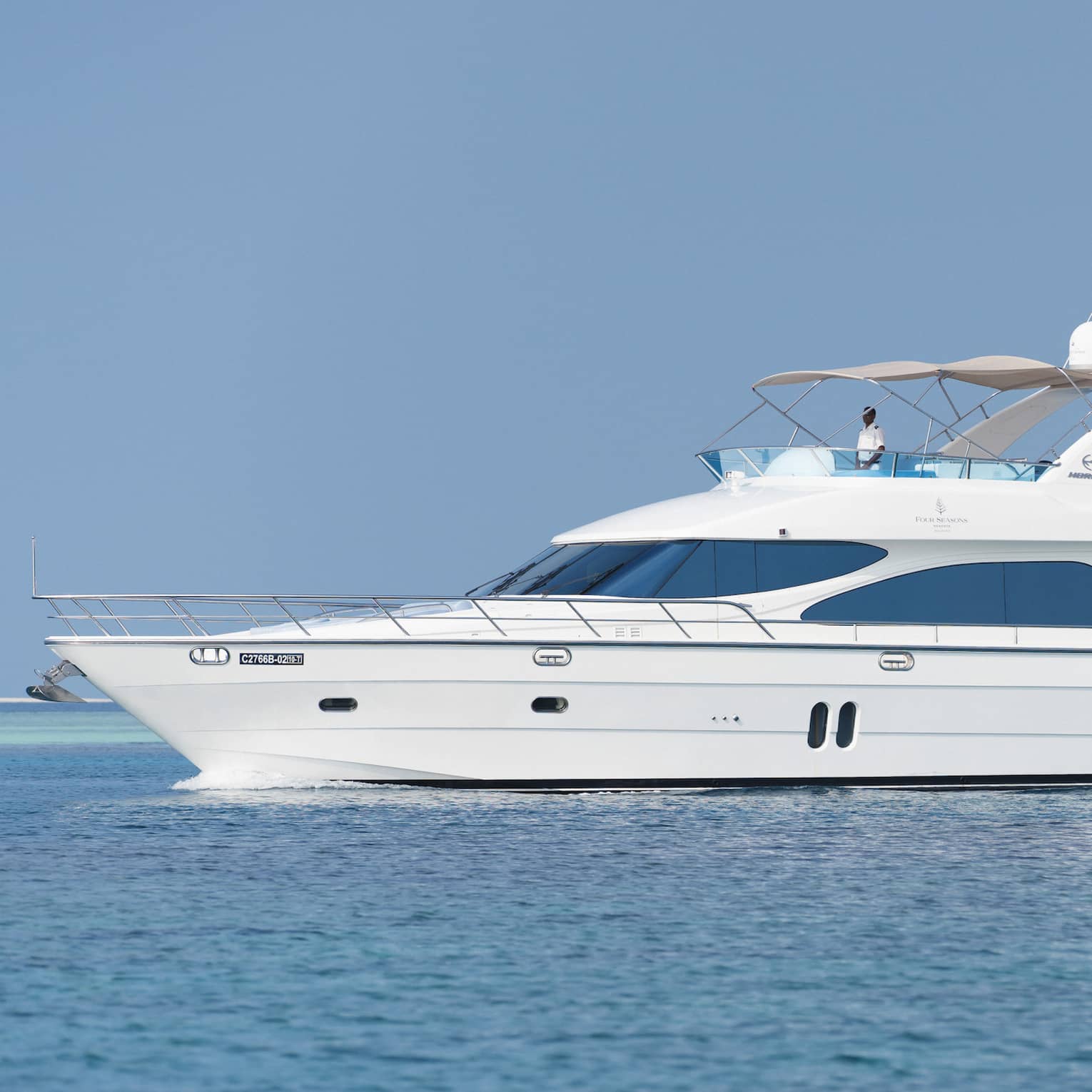 Small white private luxury yacht sailing on ocean