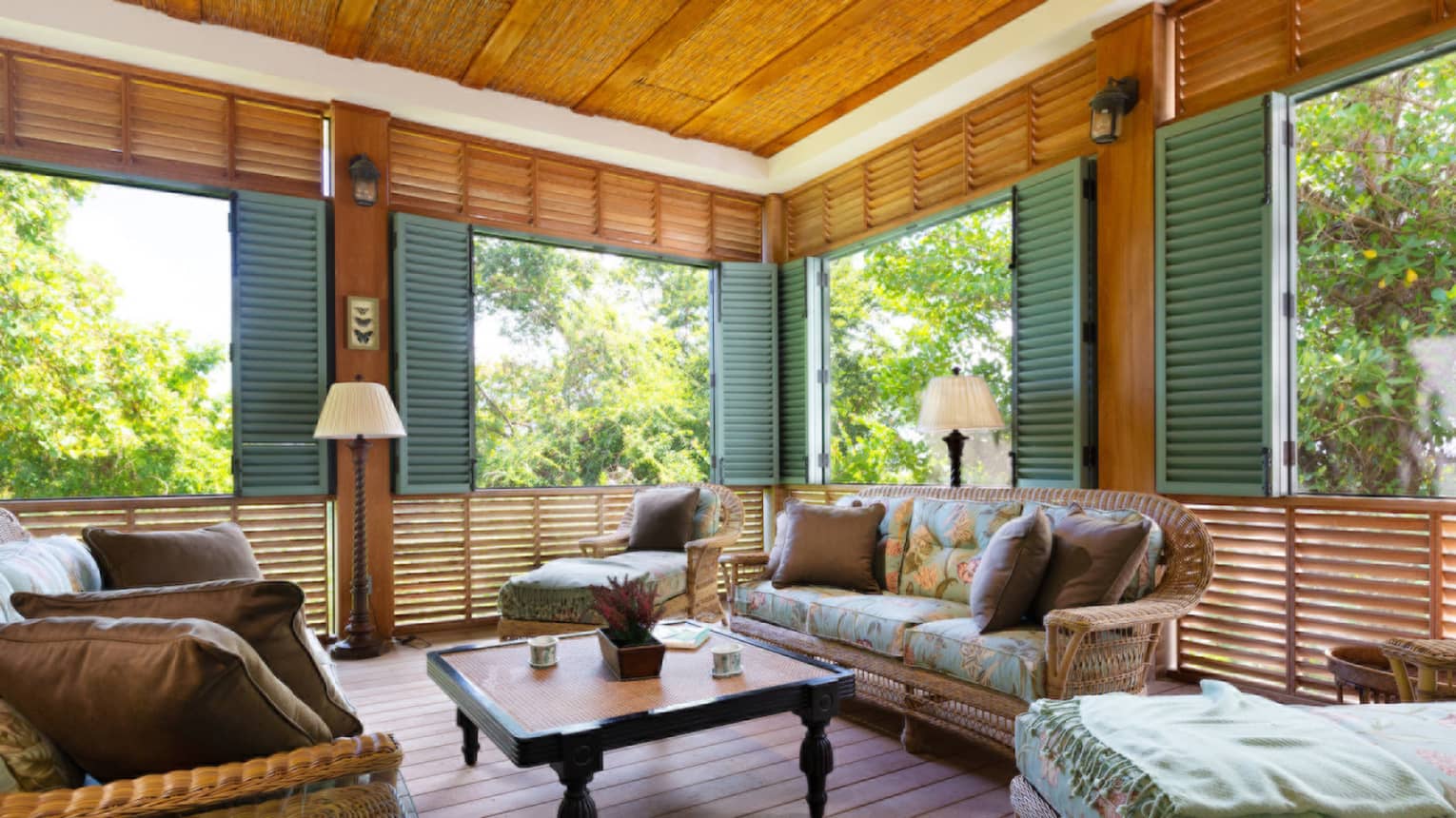 Living room with many shuttered windows, three-bedroom villa at Four Seasons Resort and Residences Nevis