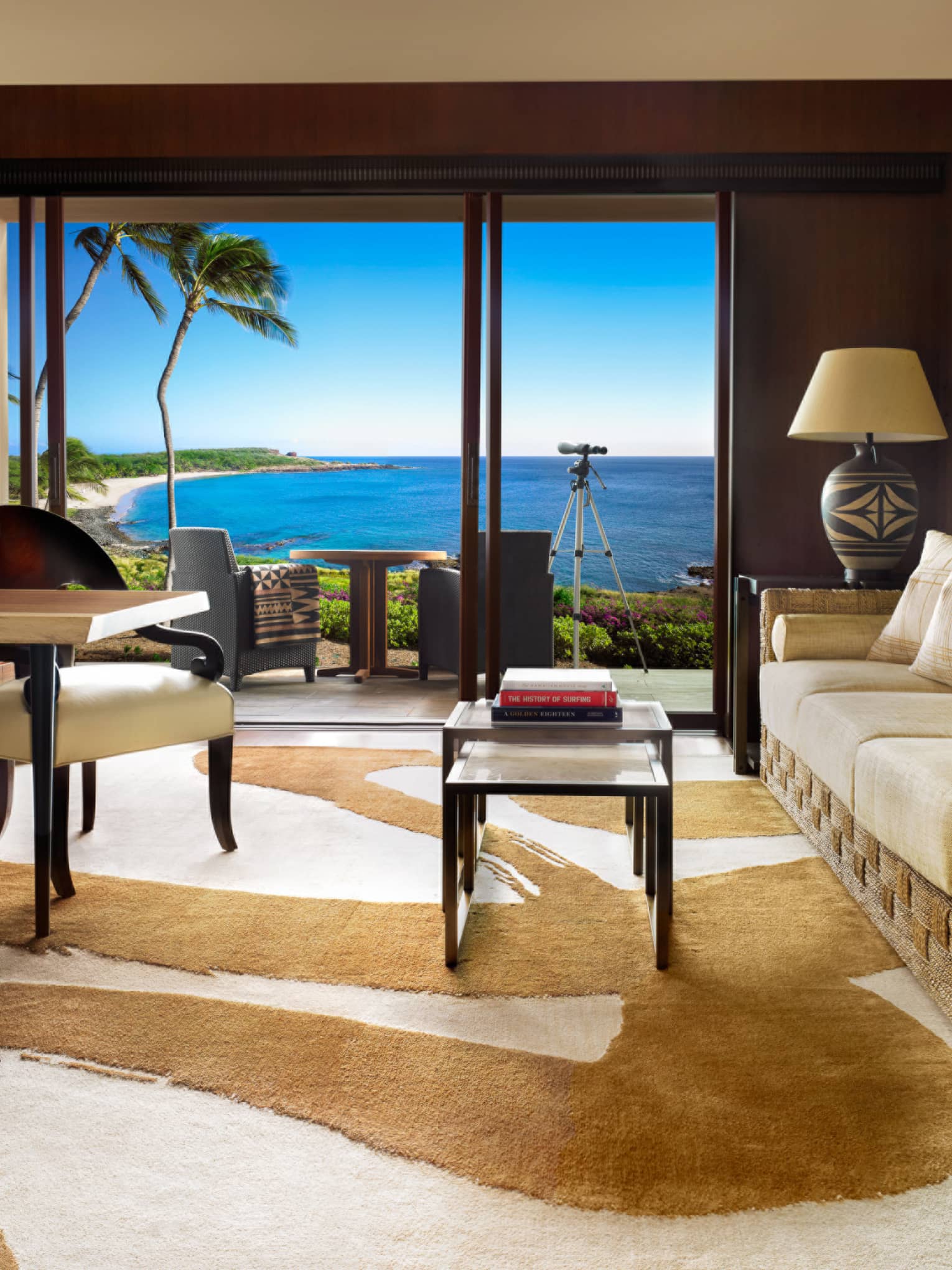 Four Seasons Prime Oceanfront Studio Suite dining chairs, table with white fish sculpture across from sofa