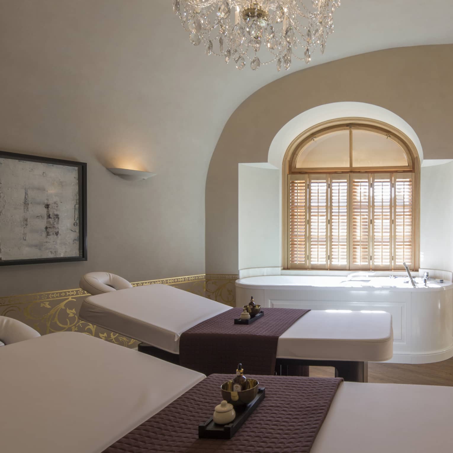 Vltava spa couples massage room with beds side-by-side, spa tub in front of window