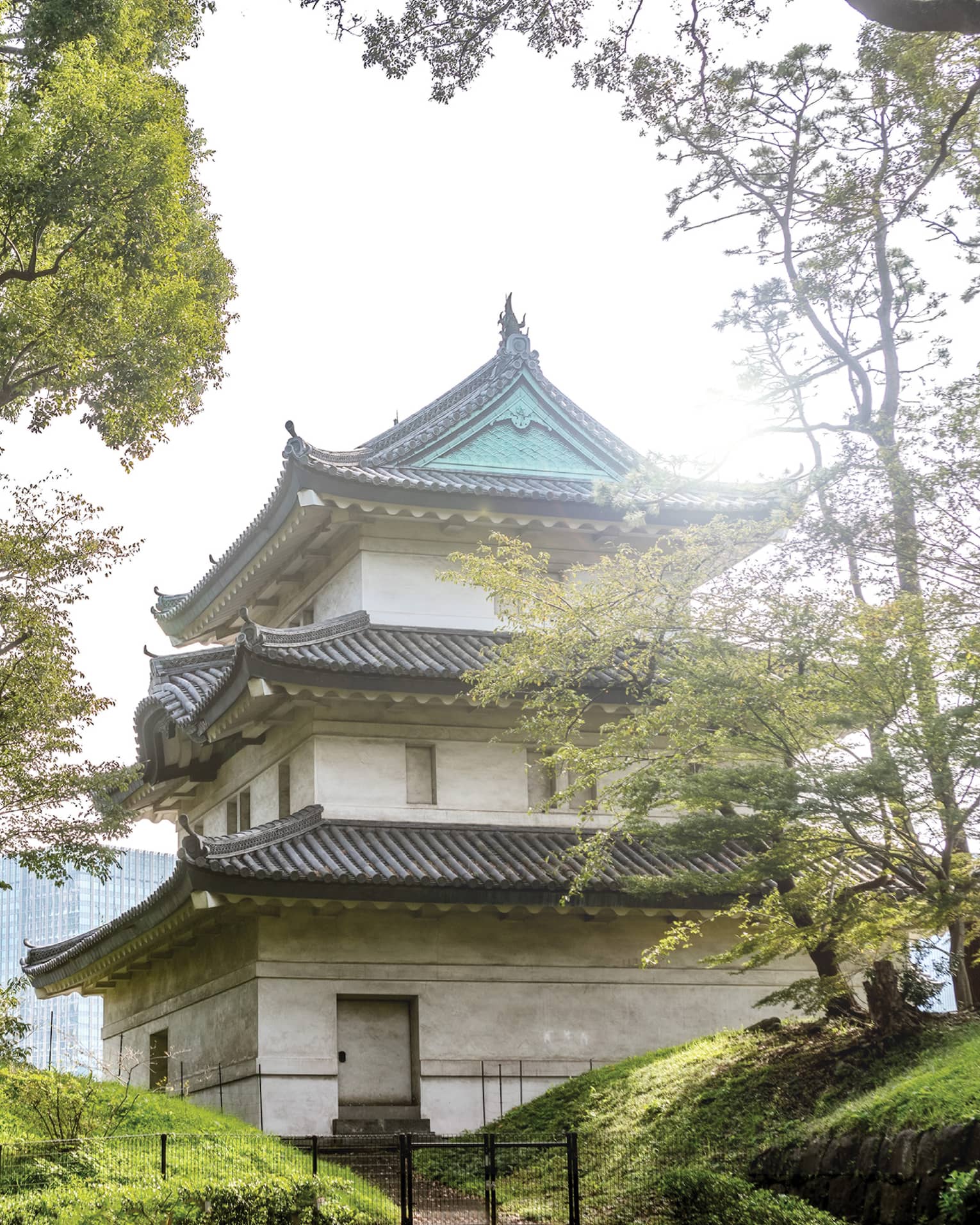 Traditional Japanese building with tiered roofs surrounded by trees