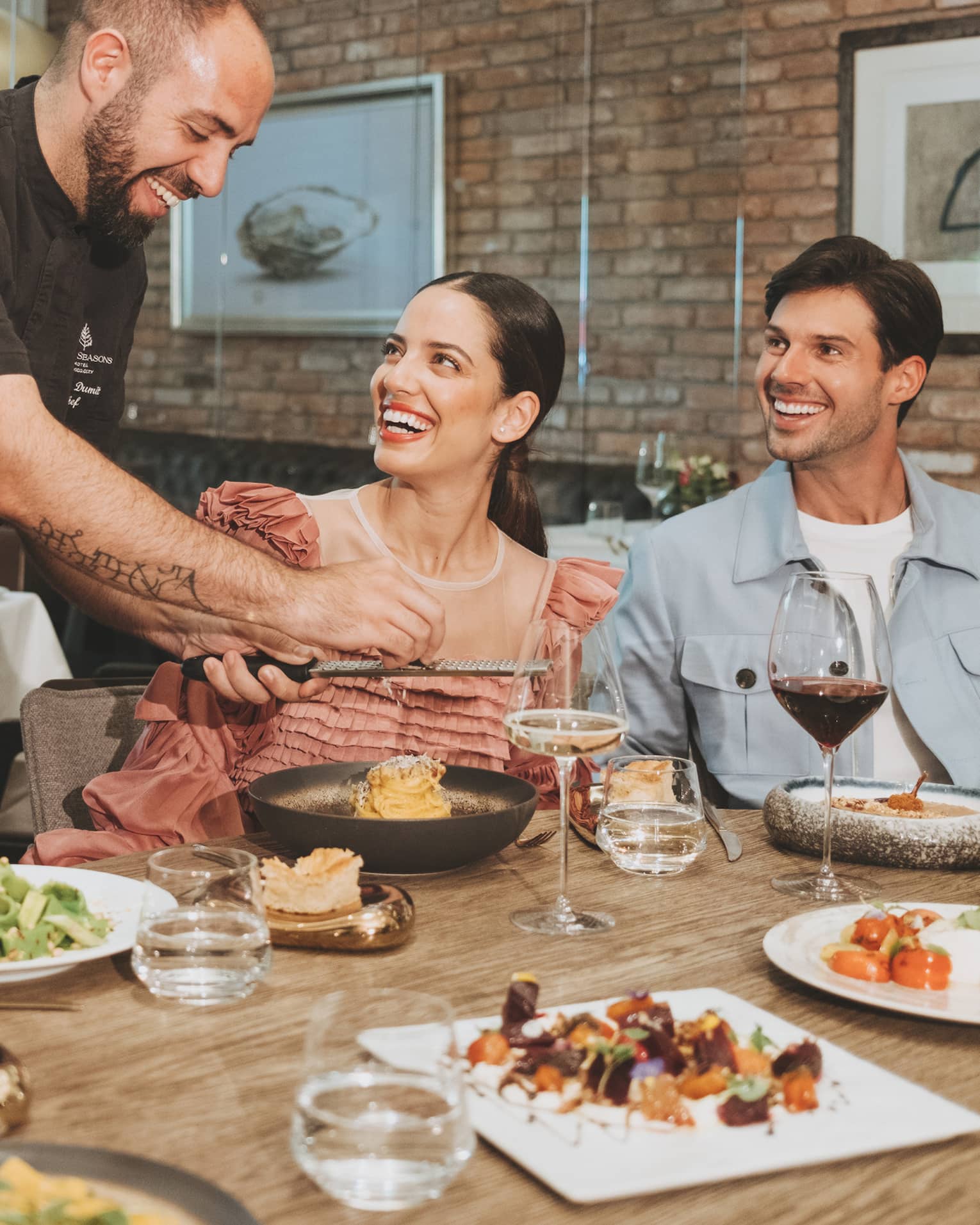 A group sitting around a round table eating food.