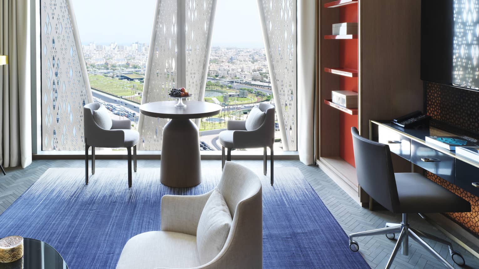 Four Seasons Executive Suite large window, modern cafe-style table, sofa, desk, shelf