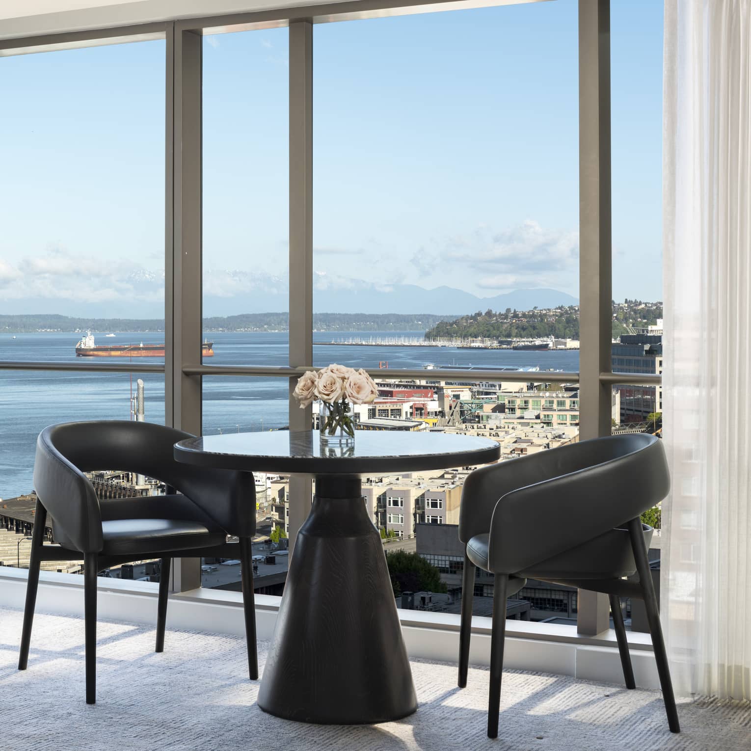 A table in the corner of the Prime Bay View Room overlooks the water and colorful buildings below