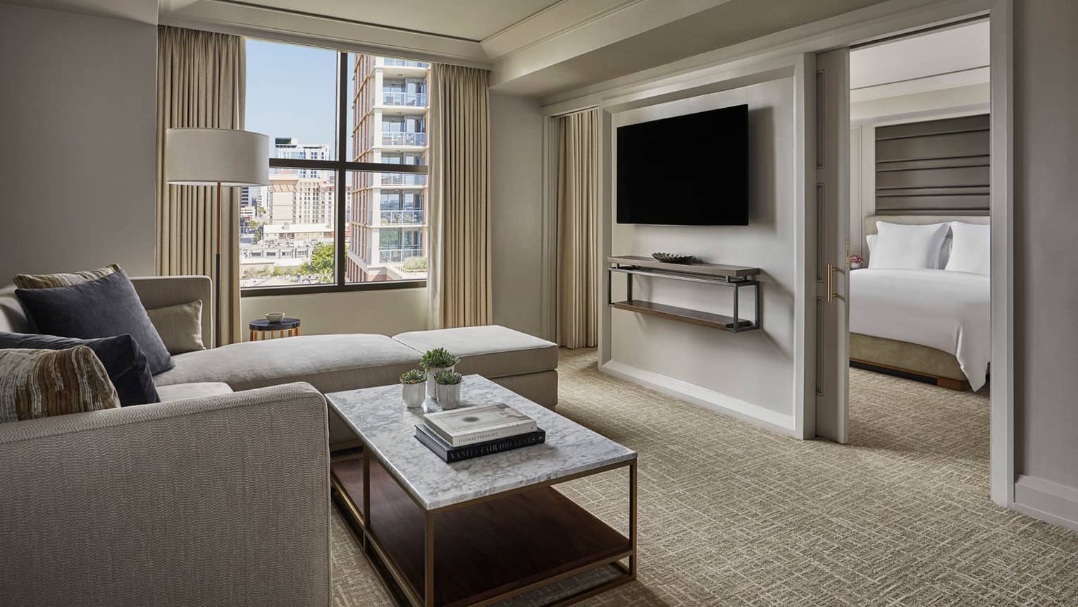 City View Executive Suite living room, window, TV on wall dividing bedroom