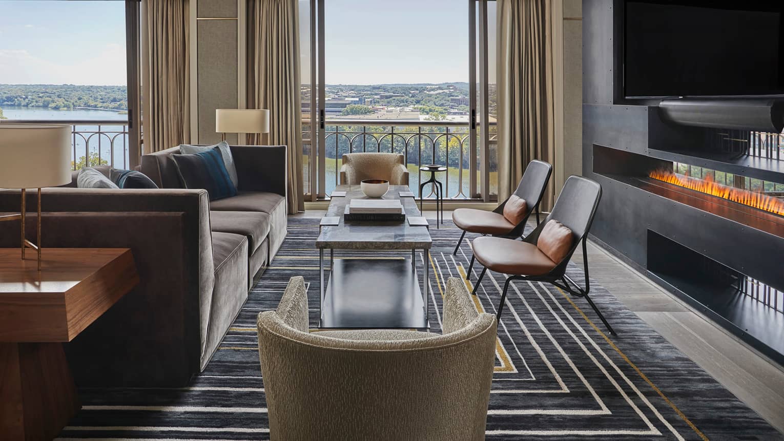 Presidential Suite large seating area by windows, modern fireplace under TV