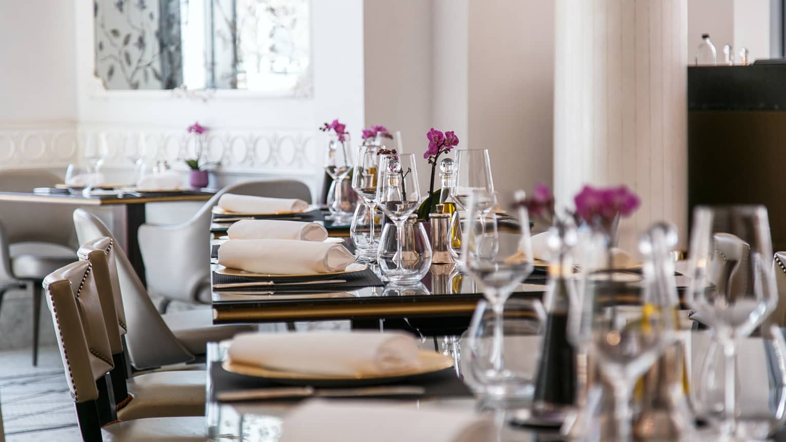 A row of dining tables set for a meal