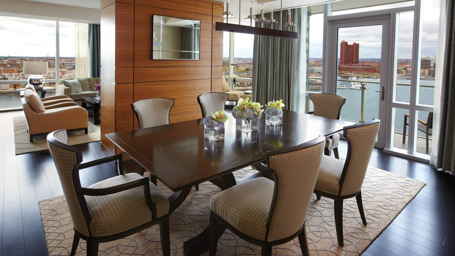 Serene Suite dining table for six, adjoining living room, glass walls with harbour view