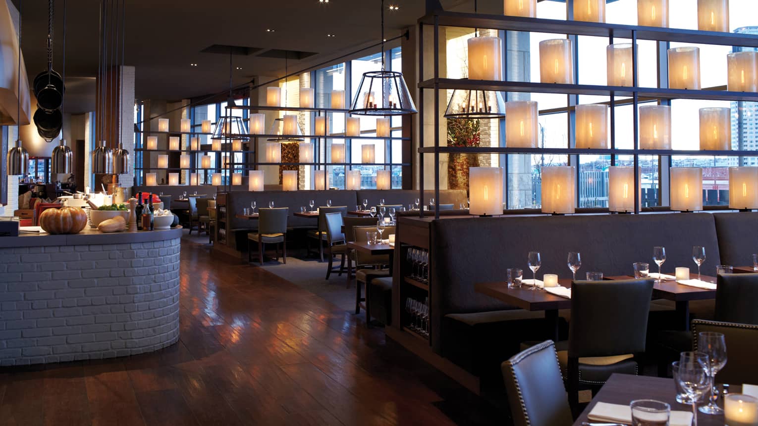 Baltimore Restaurants Fine Dining Harbor East Four Seasons Hotel Wit And Wisdom Dining Room With Light Shades In Rows Along Dividers Separating Tables