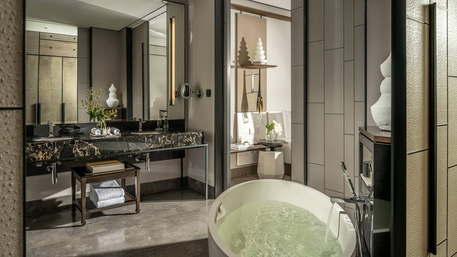 Guest bathroom, large mirror, standalone white tub, opening to bedroom