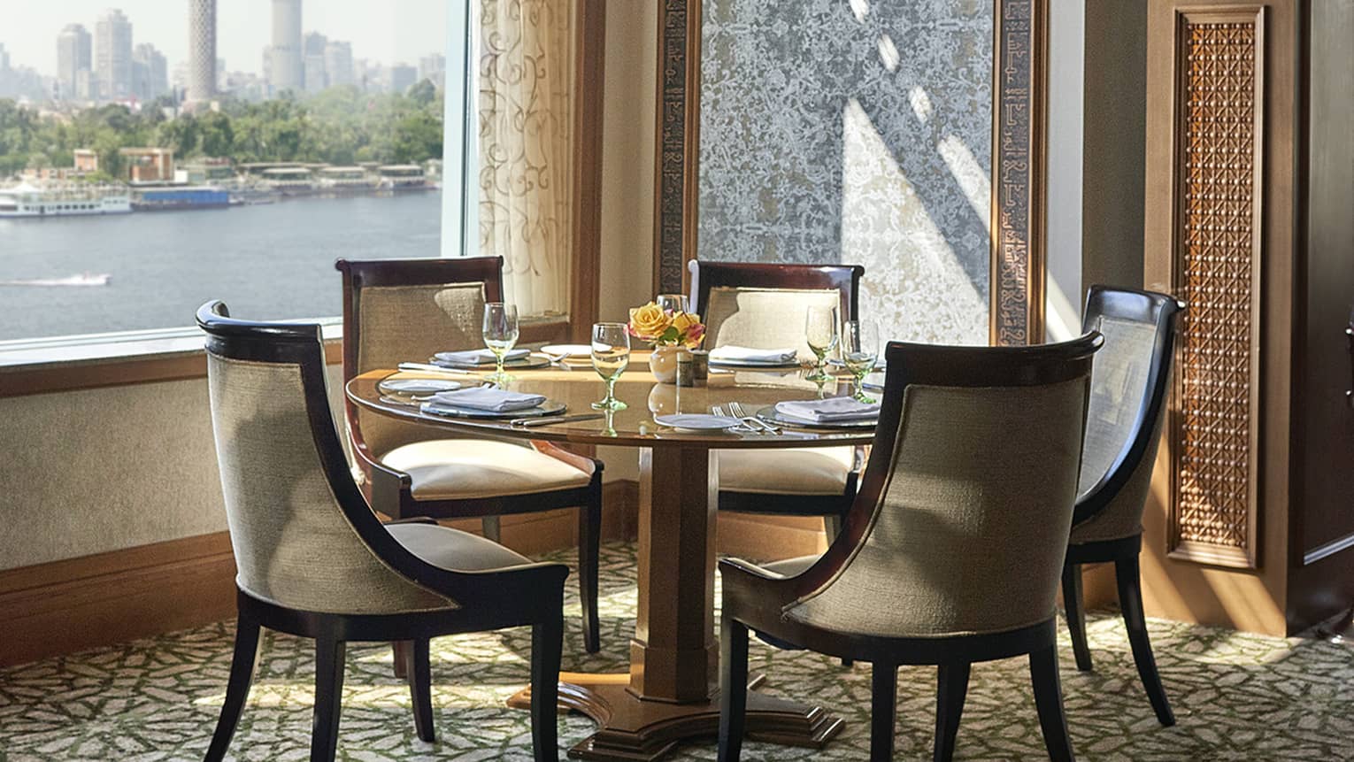 Zitouni formal dining table in front of window overlooking river