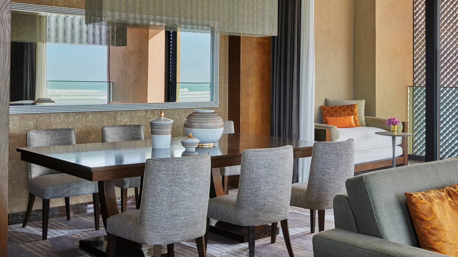 Signature Suite dining room table with grey chairs, white-and-gold ceramics