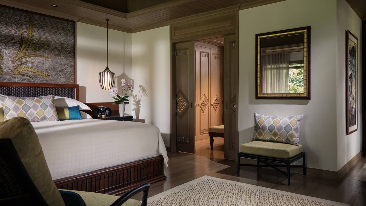 Garden Pavilion room corner of bed, hanging lamp above nightstand, chair beside sliding wood doors