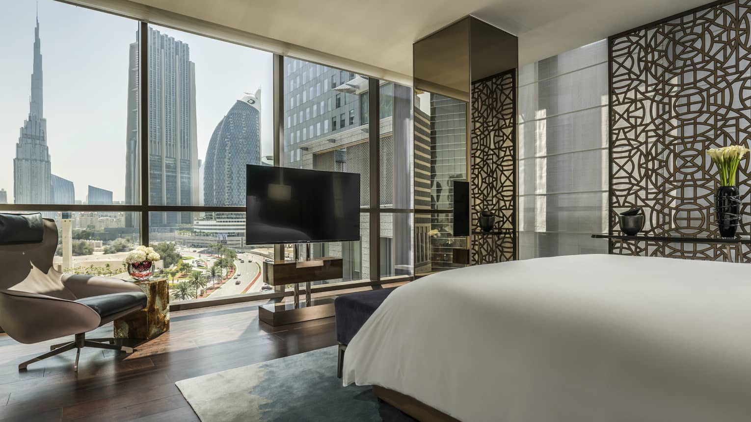 Four Seasons Deluxe Executive Suite room with bed, floor-to-ceiling window with Burj Khalifa view 