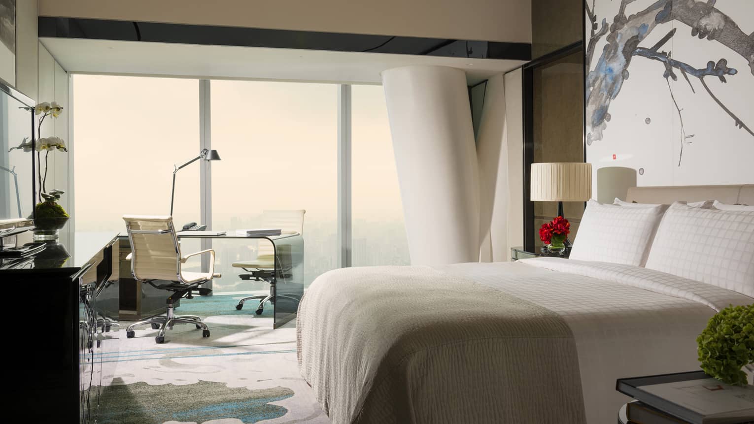 Tower Room with View bright decor with white bed, white and blue carpet and art, floor-to-ceiling window