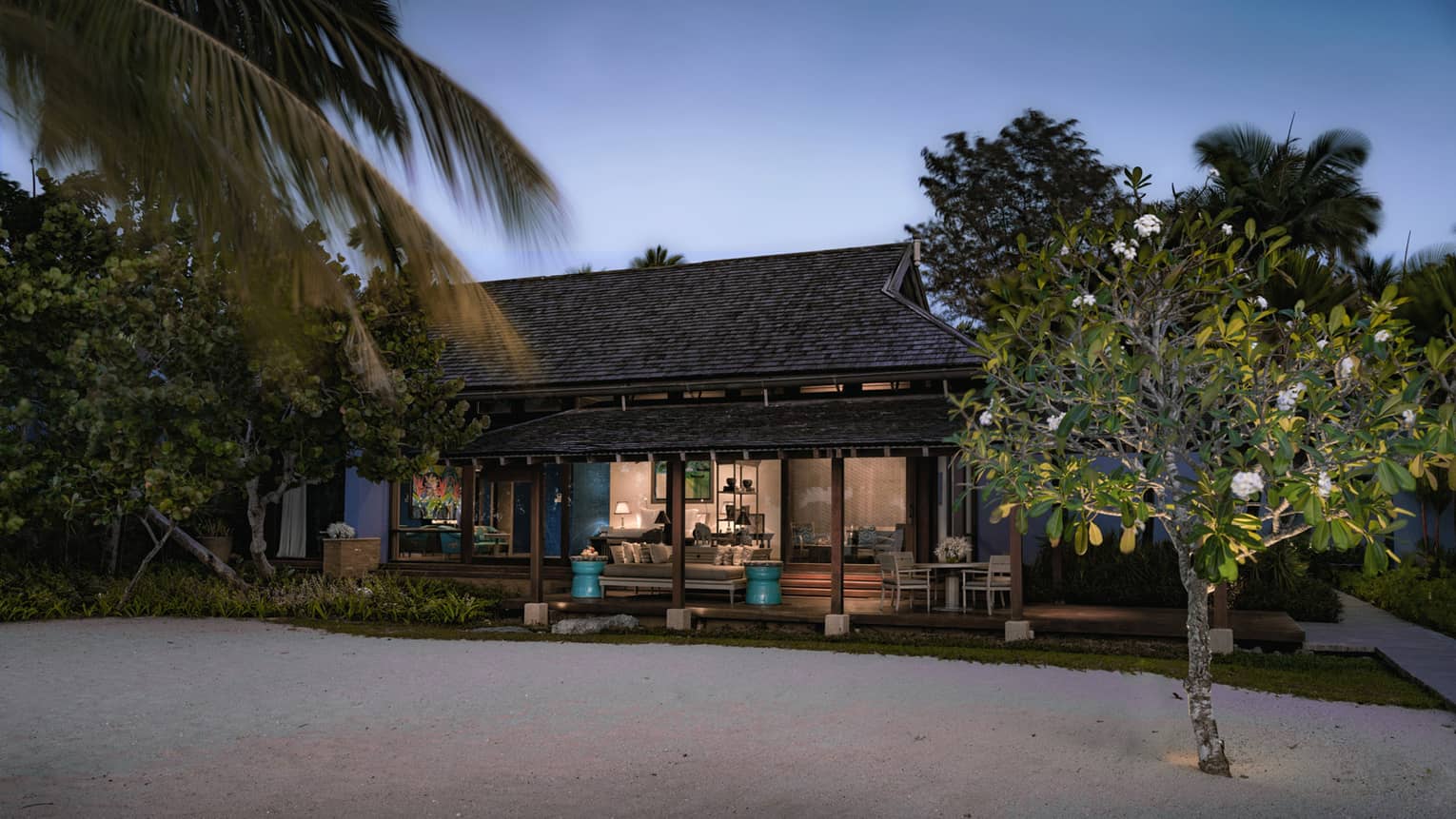 Deluxe Family Beach exterior at night with lights from sandy beach