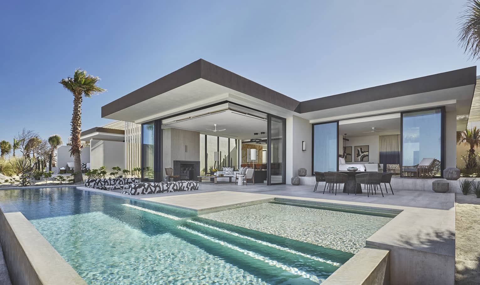 Modern outdoor terrace of presidential suite, dining table, long rectangular pool
