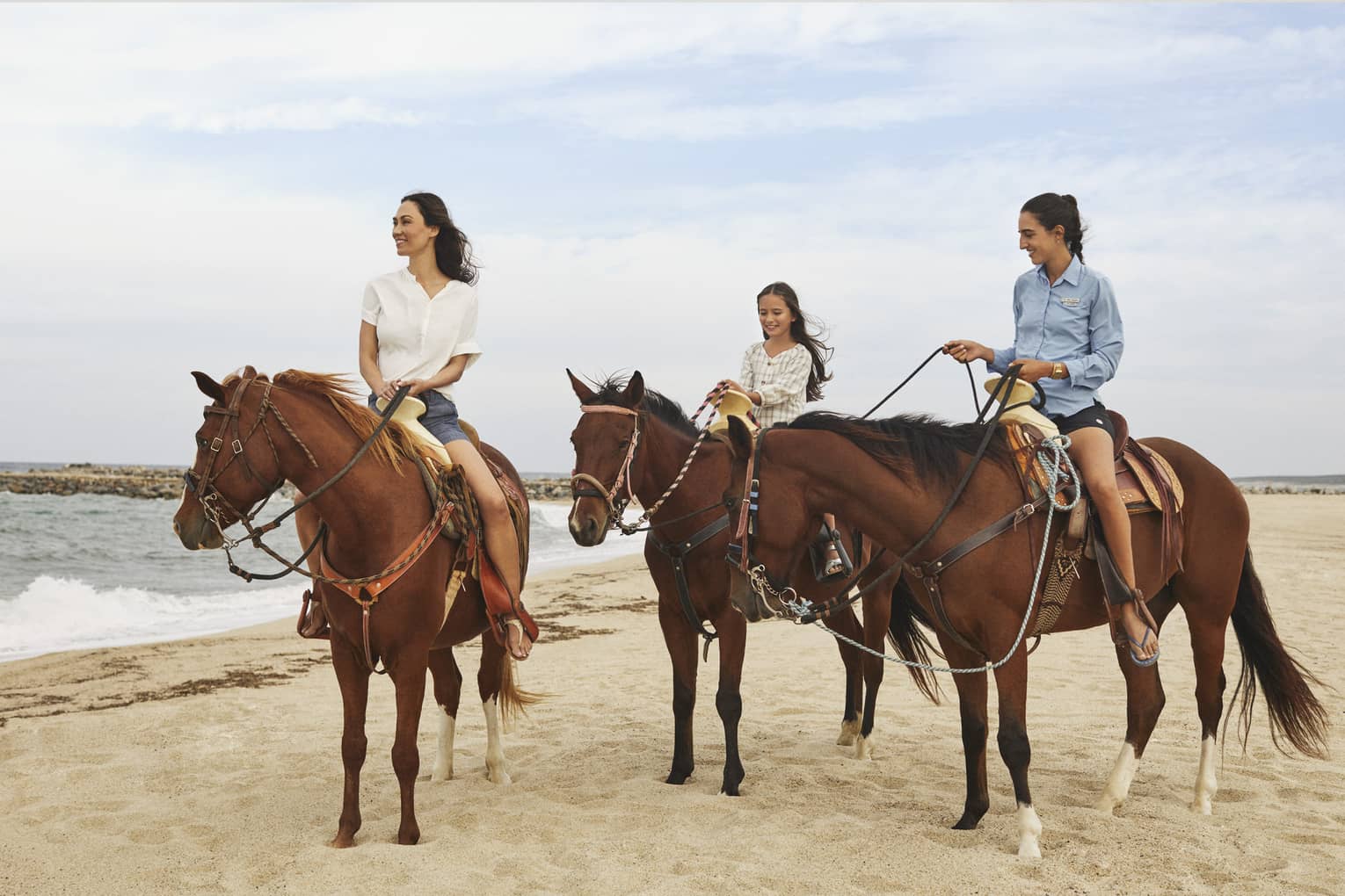 Three women riding on horses.