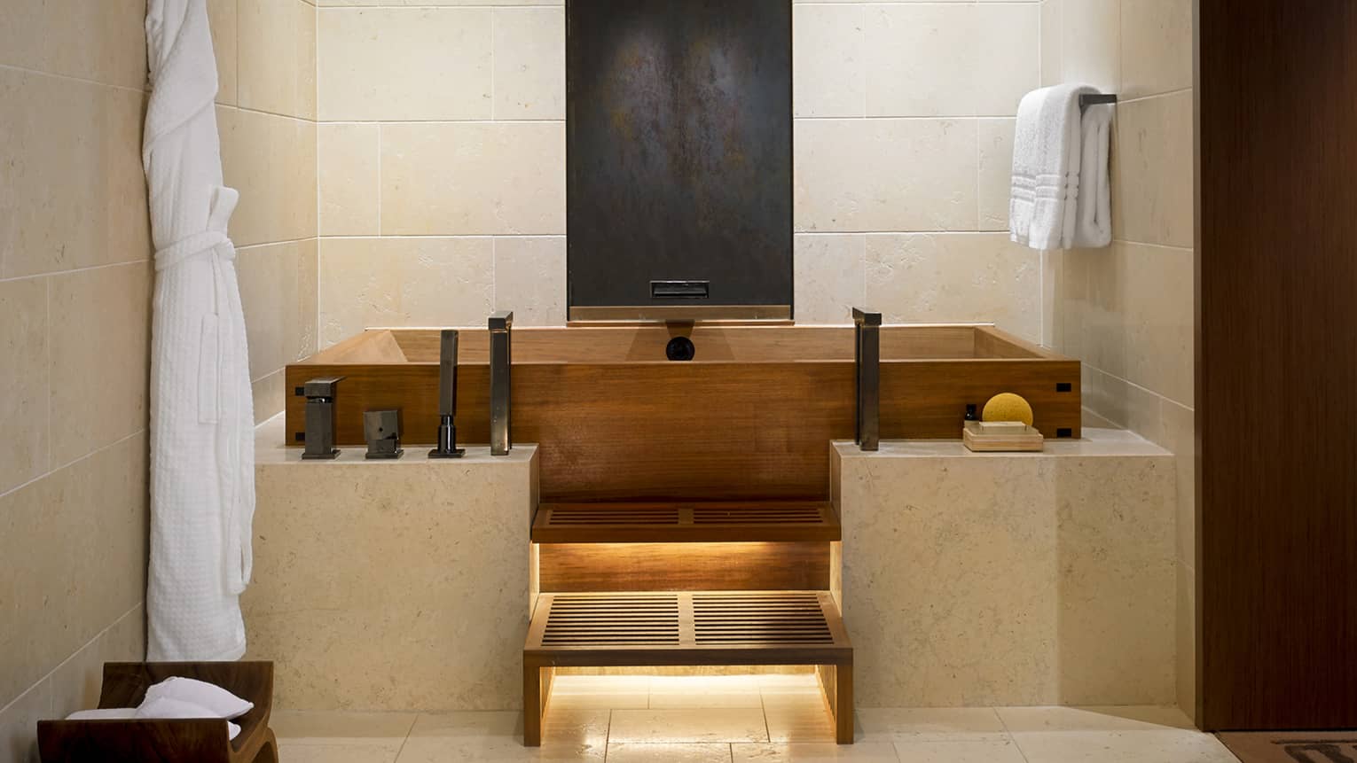 Alii Royal Suite master bathroom with modern wood Japanese soaking tub, marble ledge, tile walls