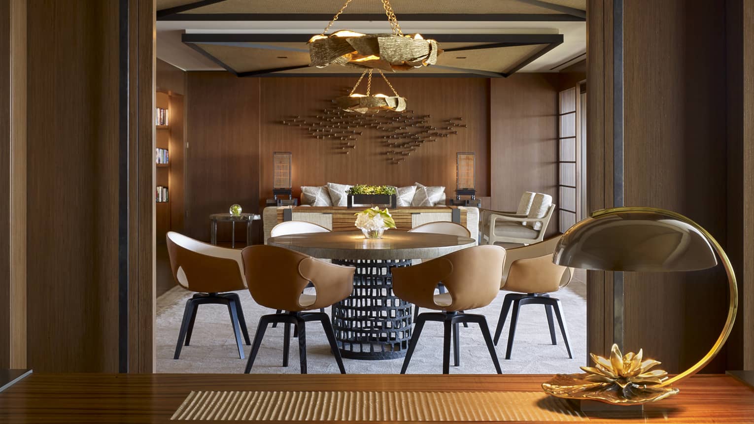 View past modern table lamp and doorway to Alii Suite Dining Room table