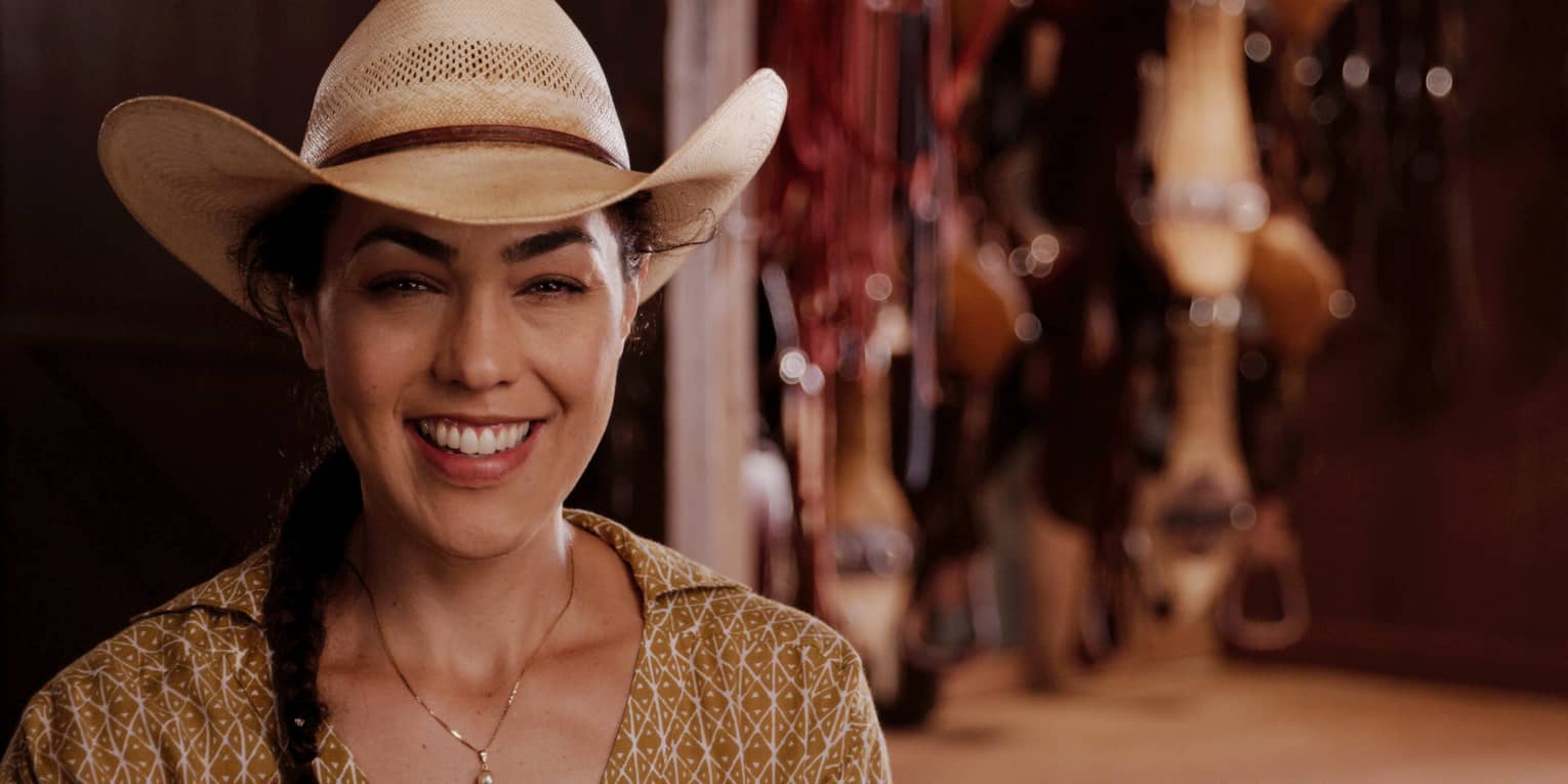 Lanai staff member wears a cowboy hat at a cattle ranch