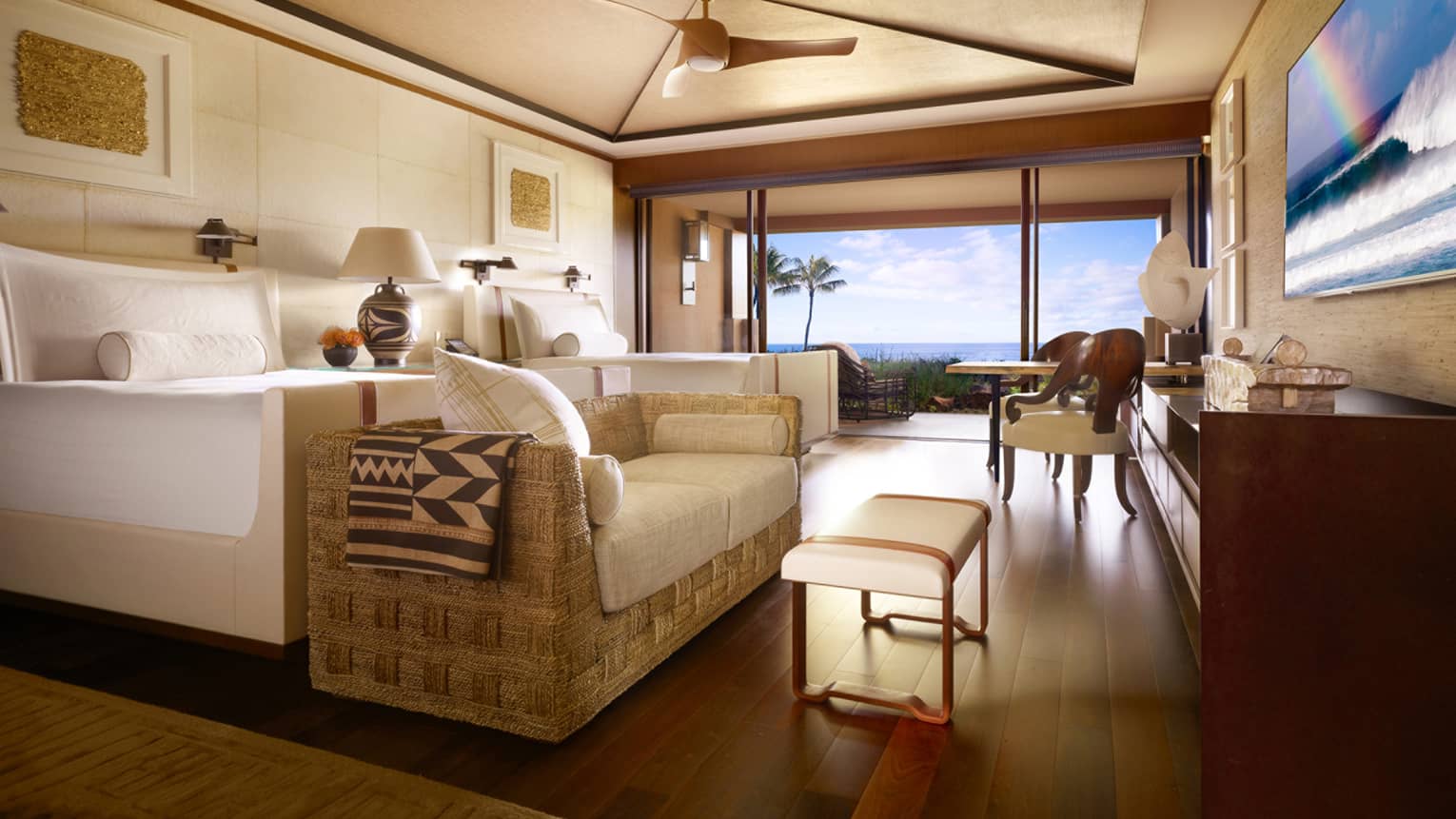 Ocean-front room with rattan loveseat with white cushions in front of bed, second bed, white bench, large window