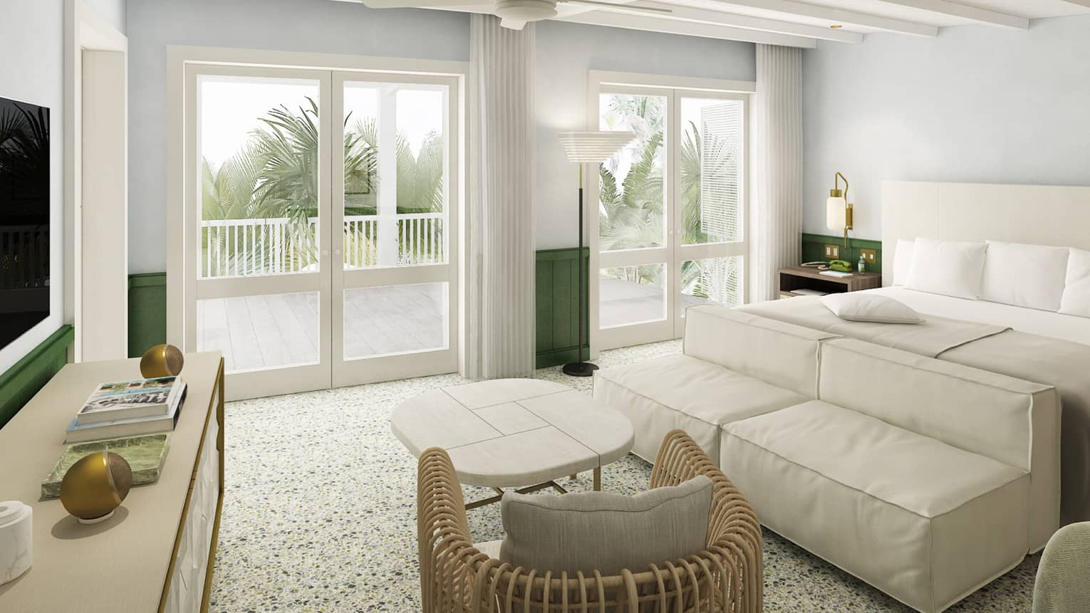 Room with white and green decor, bed, versatile sofa and rattan chair with cafe-style table