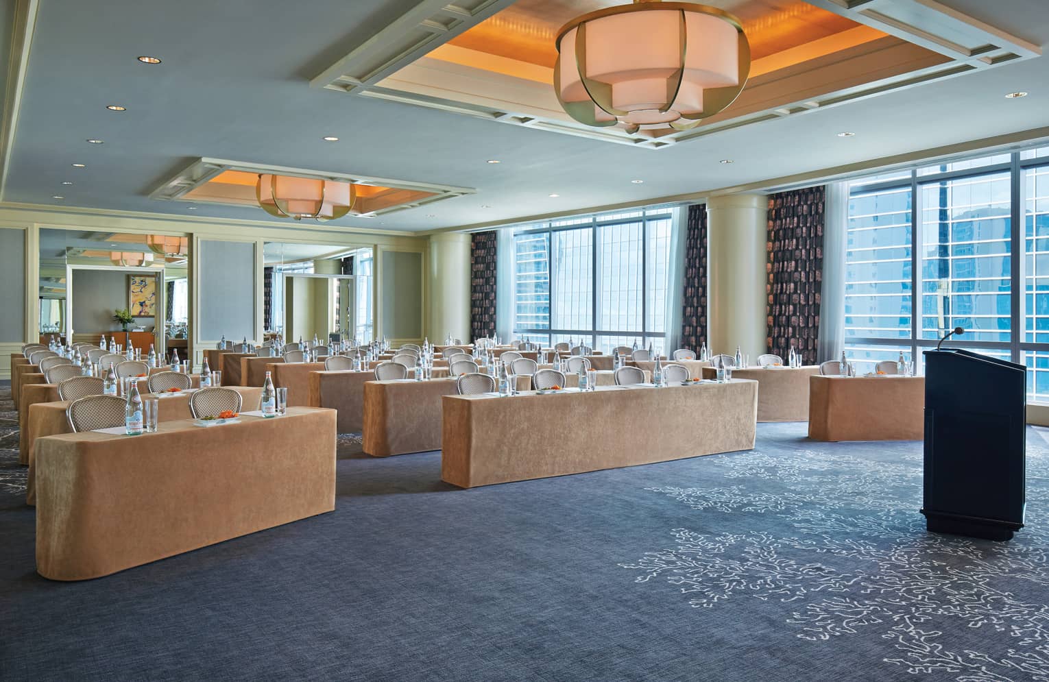 Rows of meeting tables in bright function room