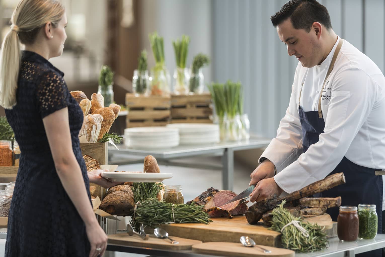 A chef cutting steak for a guest at the Sky Bridge