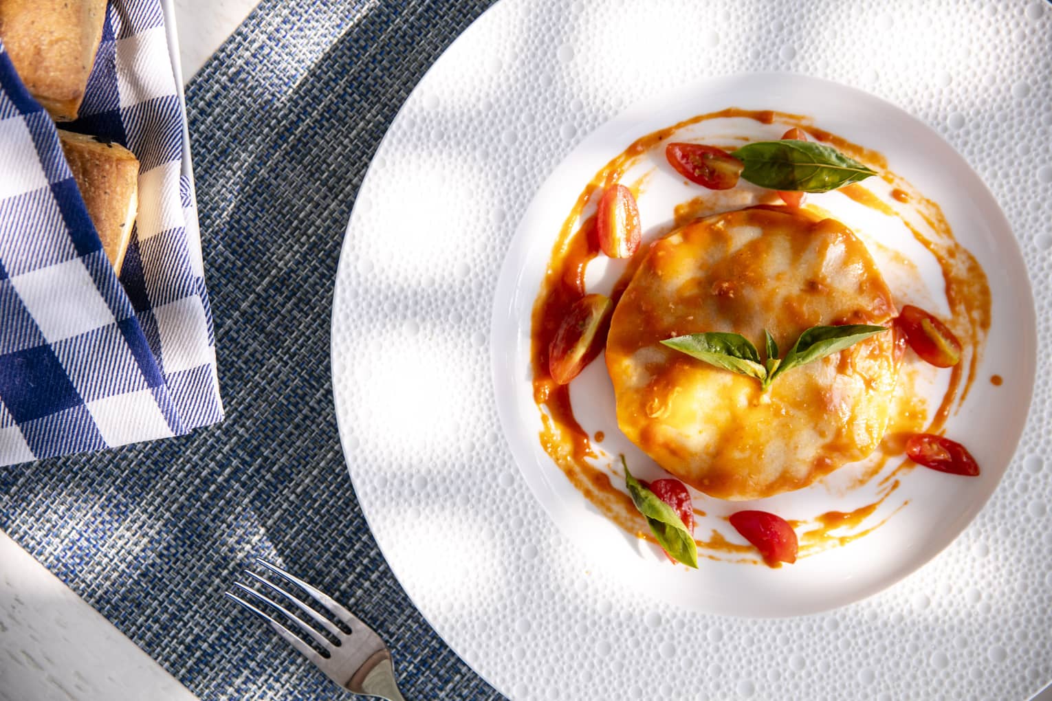 an aerial shot of a tomato and egg dish with basil on top in Four Seasons Maldives - Landaa