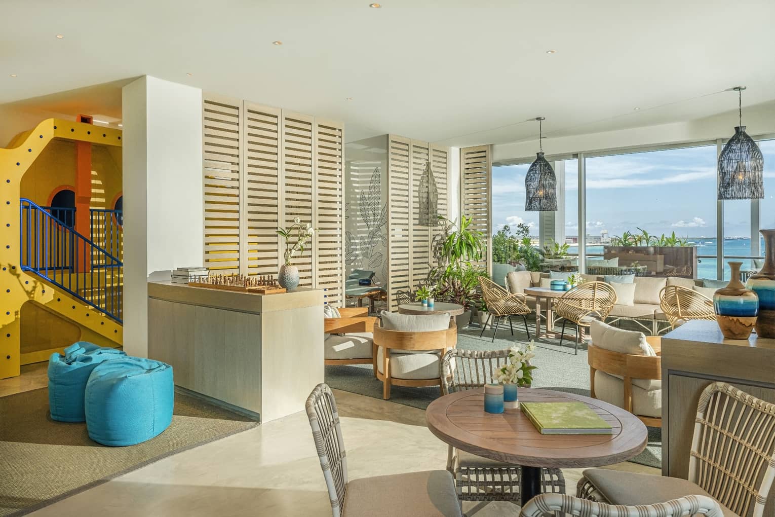Seaplane lounge with relaxation area and floor-to-ceiling windows with ocean views