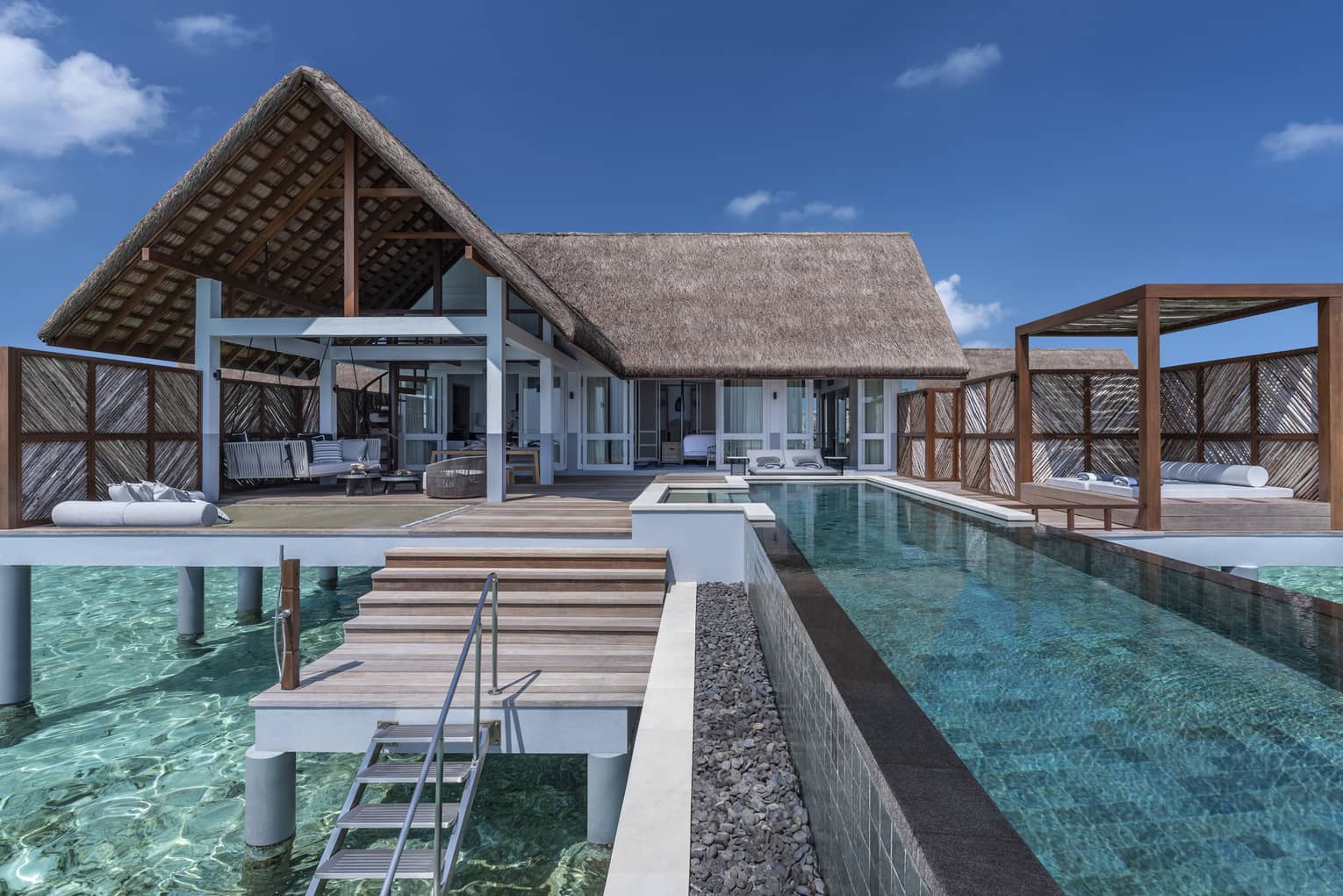 Over-water villas with private pools and furnished decks
