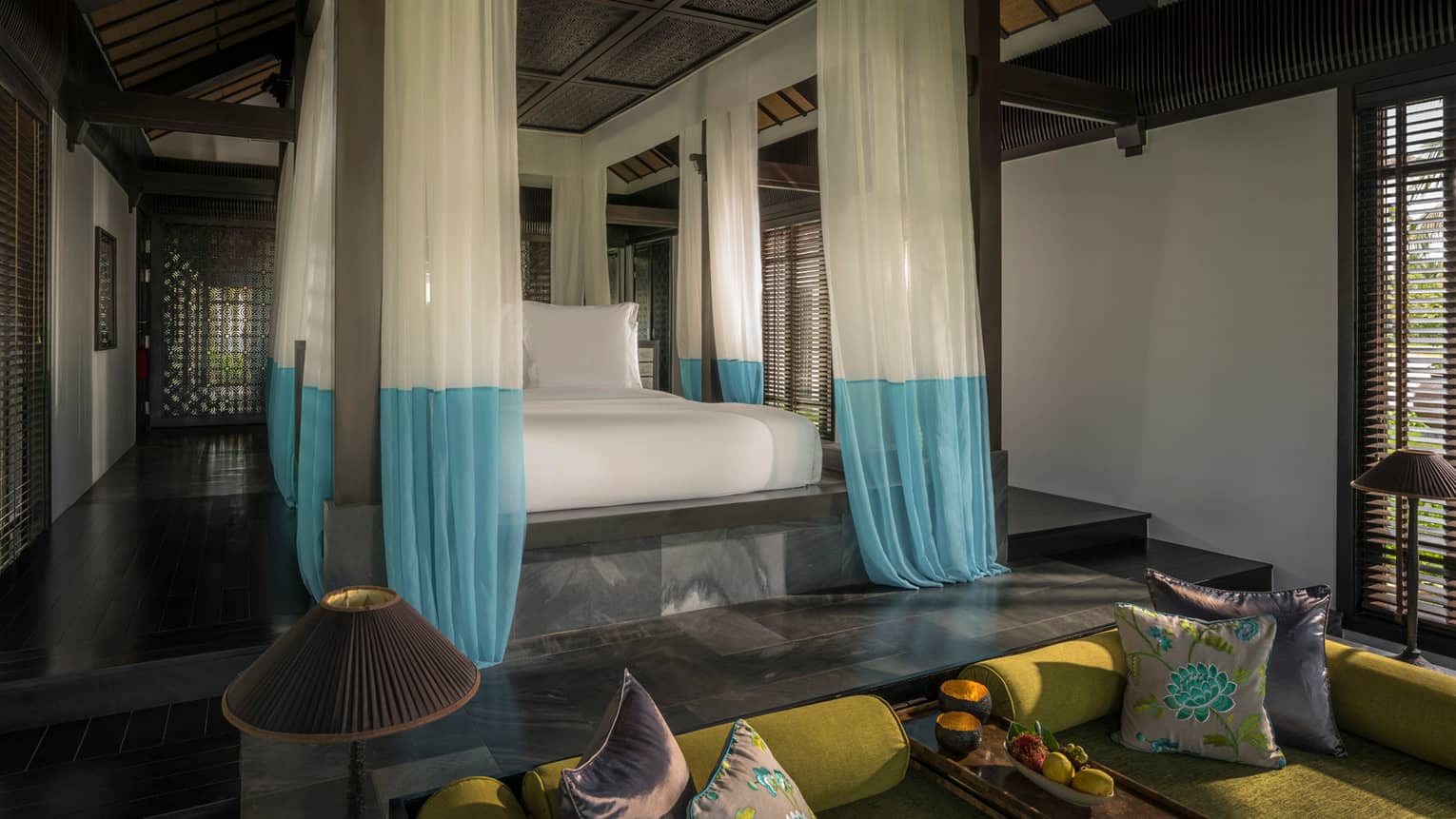 Villa raised platform poster bed with white-and-blue gossamer drape canopy