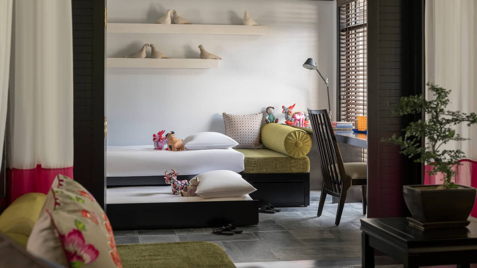 Family Villa bedroom with two children's day beds, ceramic birds on shelves