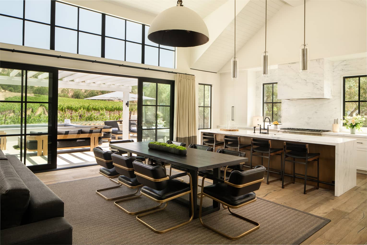 High-ceilinged kitchen and dining room of farmhouse-chic residence