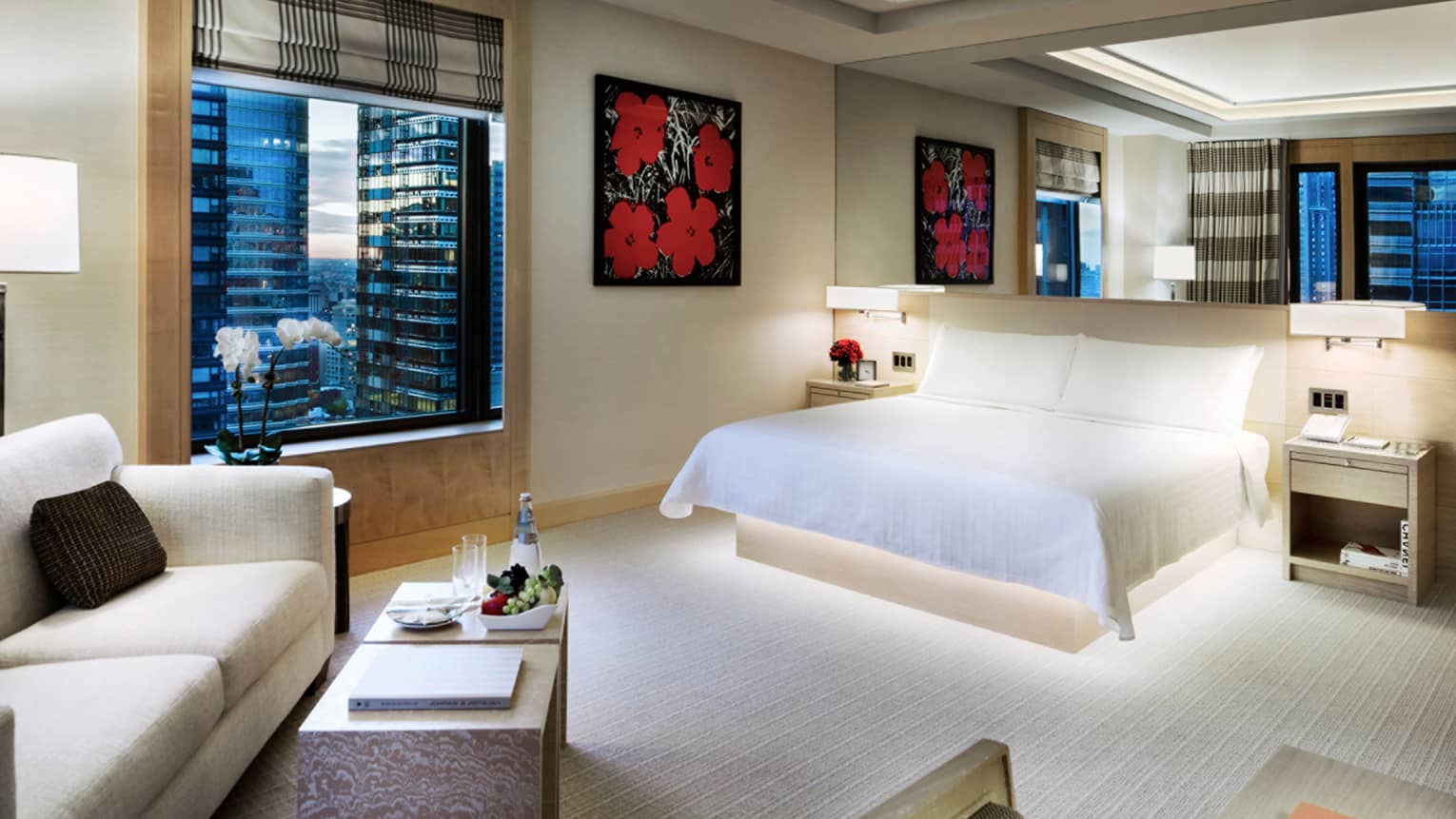 Manhattan Junior Suite King bed under mirror, print of red flowers, seating area