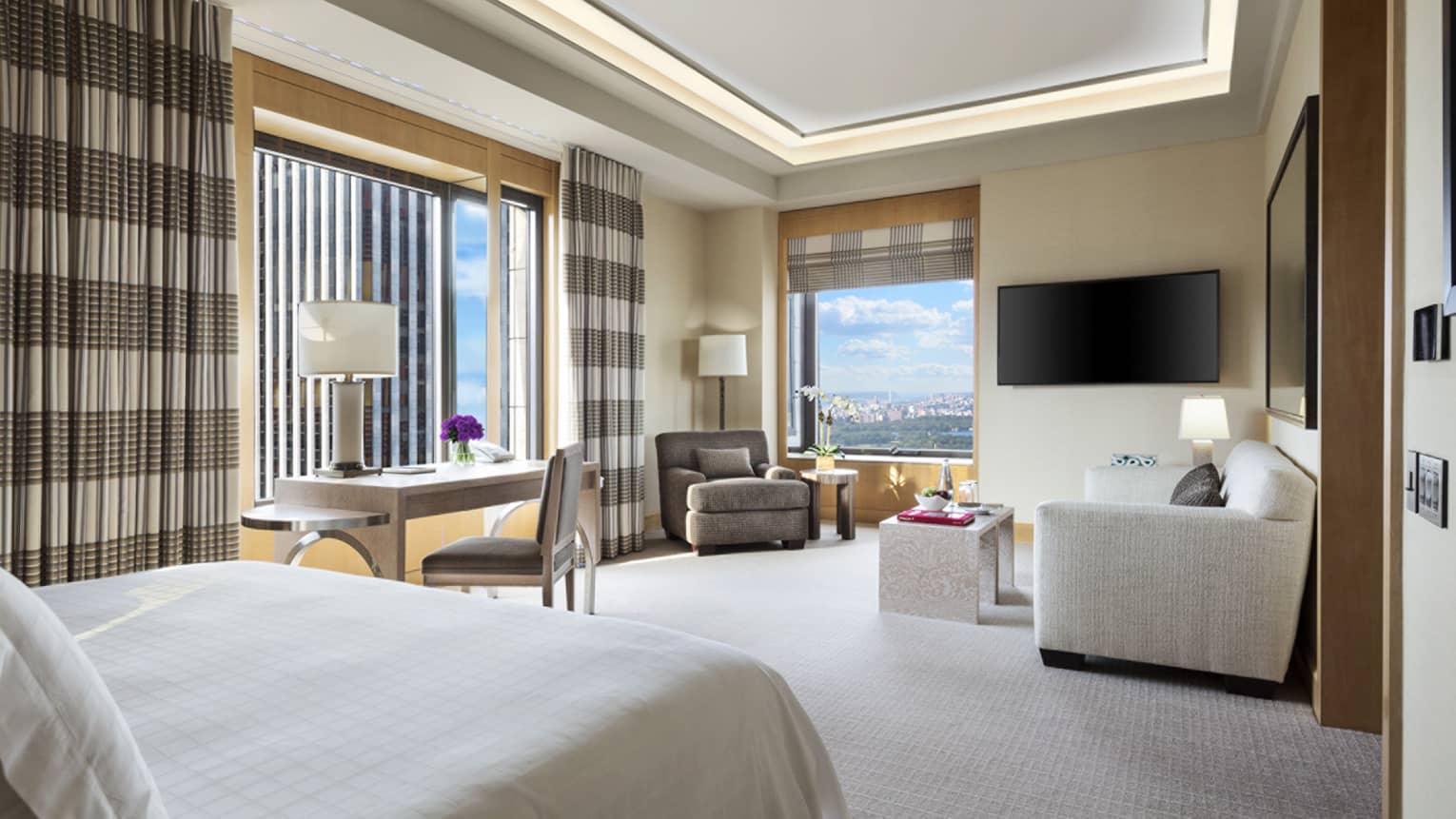 Central Park Junior Suite end of bed, long striped curtains on windows, sofa, chair