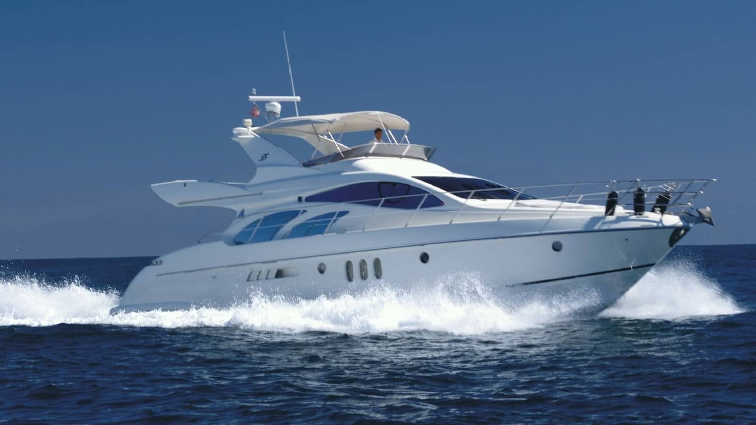 White Four Seasons private luxury yacht speeds across ocean