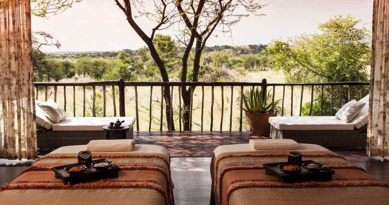 Spa couples massage beds with trays side-by-side in front of patio