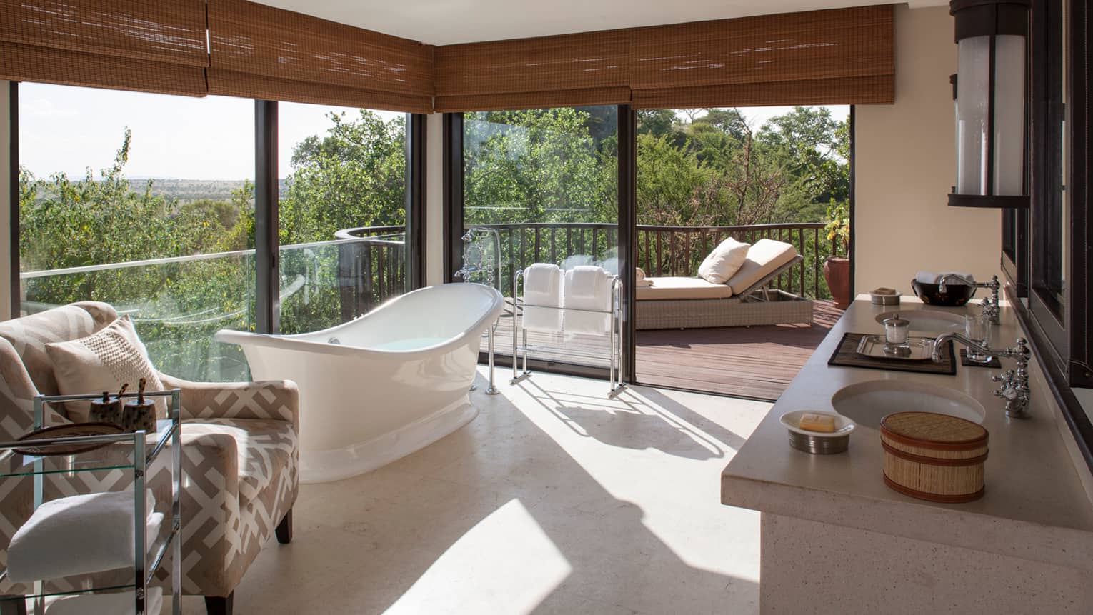 Presidential Villa bathroom freestanding white tub, armchair by floor-to-ceiling corner windows