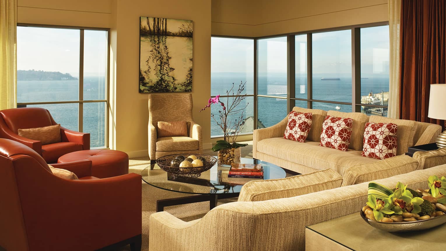 Presidential Suite sofas, red leather armchairs in front of corner windows with bay views 