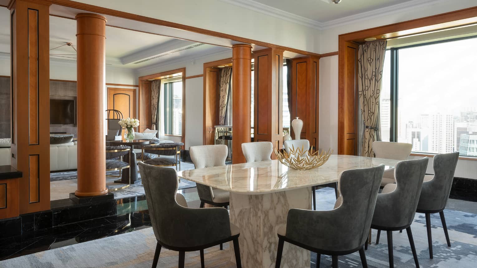 Presidential suite dining area with marble table and floor-to-ceiling windows