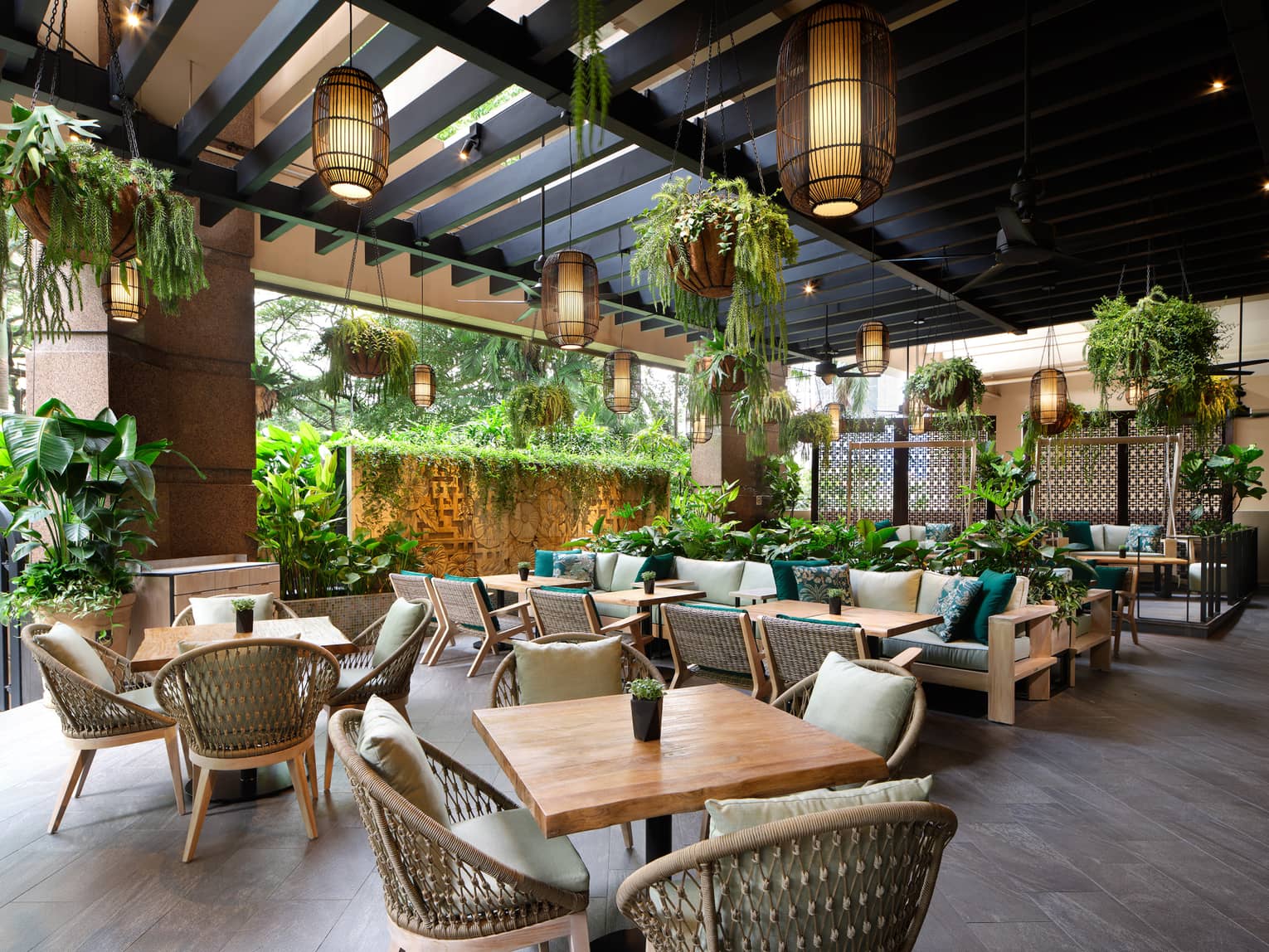 Garden@One-Ninety outdoor lounge with rattan chairs, square tables for four, portico ceiling, hanging plants and lighting