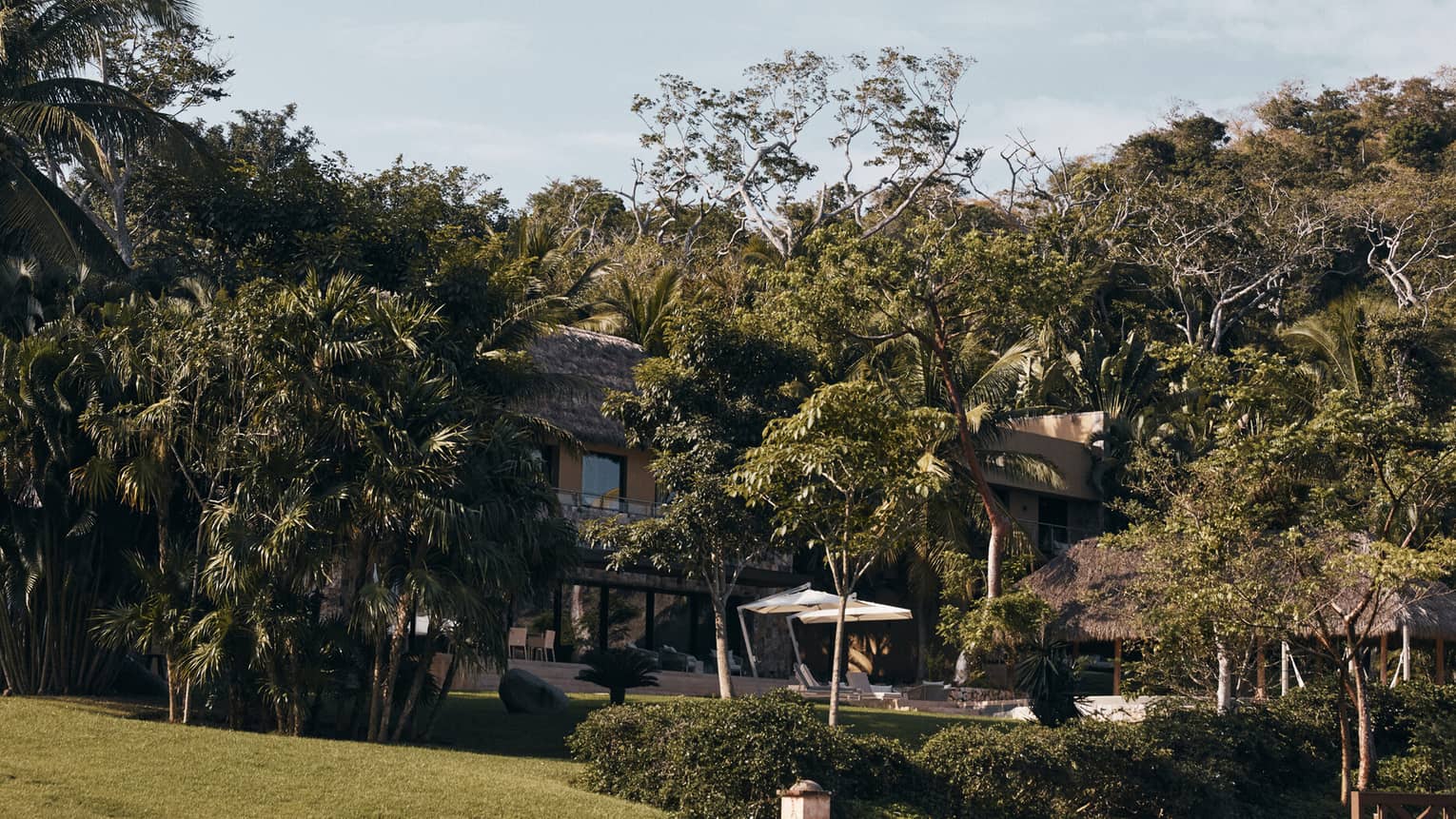 Exterior of Casa Vista six-bedroom residence at Four Seasons Resort Tamarindo, surrounded by lush tropical foliage